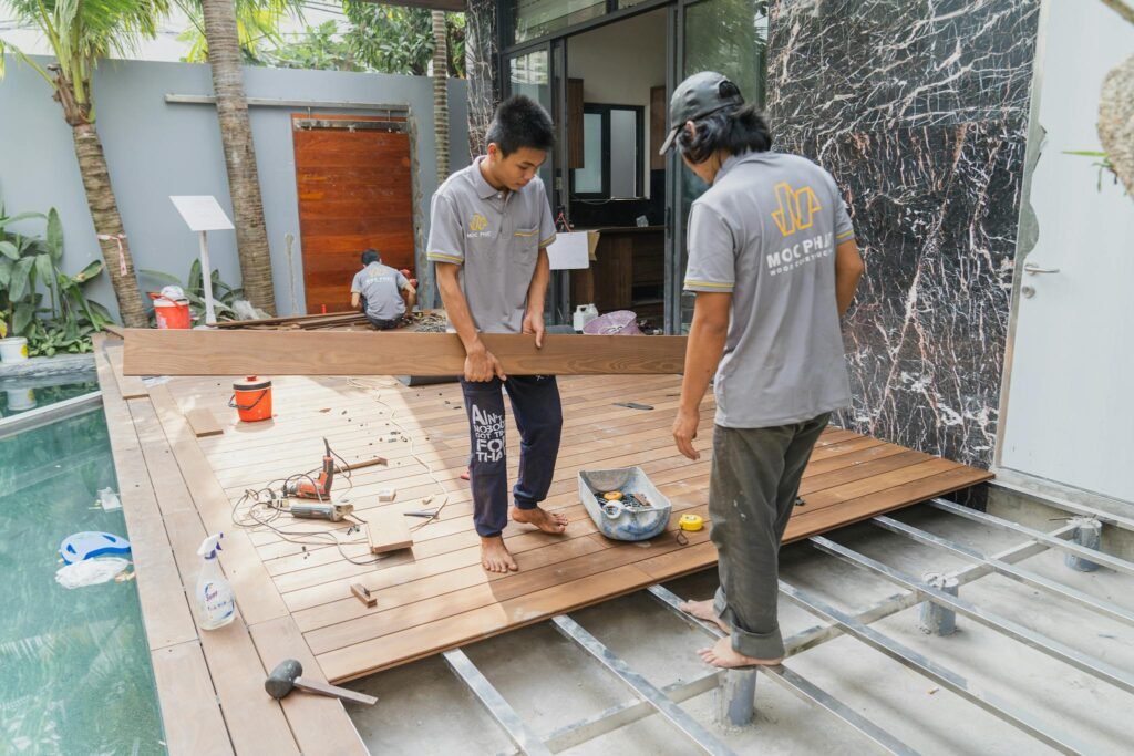Carpenters working on a wooden floor installation in Hồ Chí Minh, Việt Nam.